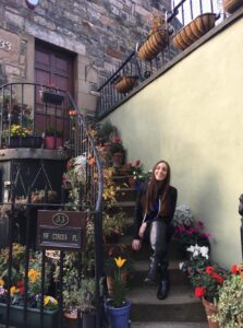 Student sitting on flowerpot lined stair