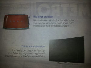 Photo of part of a newspaper page, including the toaster image and text: "This is not a toaster, it's..."