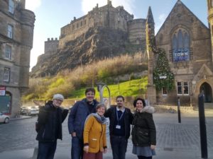 Group of people pose in the street with Edinburgh Castle in the background