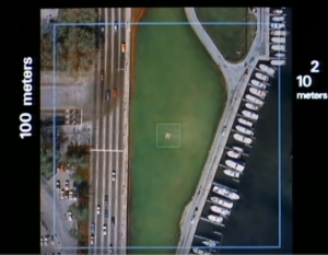 Overhead view of a par with nearby highway and marina. 