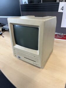 A front on image of an old Macintosh SE all in one computer 