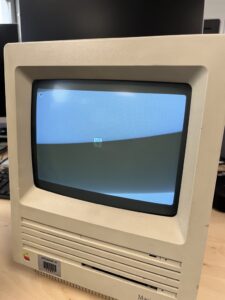 A front on image of an old Macintosh SE all in one computer 