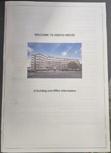A white leaflet with black text that says welcome to Argyle house. There is an image of Argyle house, which is an multi storey office building located in Edinburgh 
