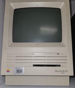 A front on image of an old Macintosh SE all in one computer 