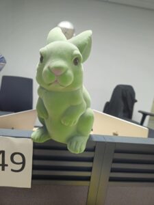 A flocked green figurine of a rabbit