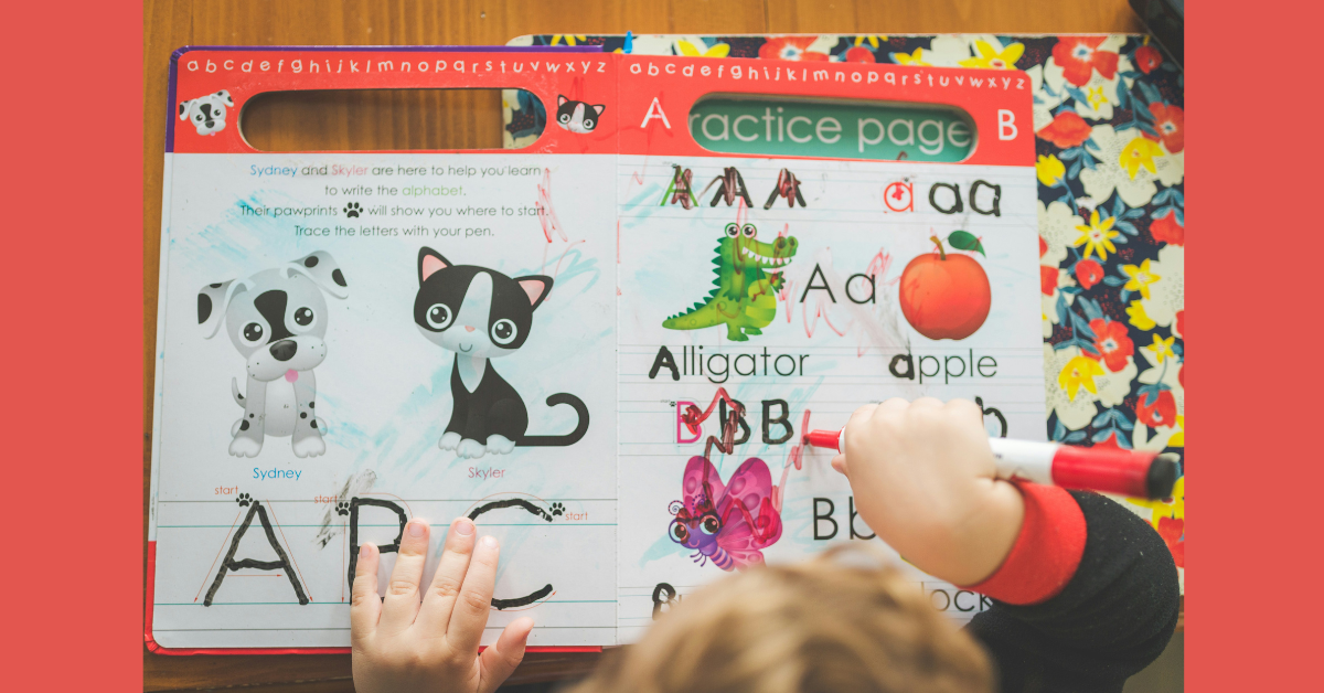 A young boy writing on a piece of paper