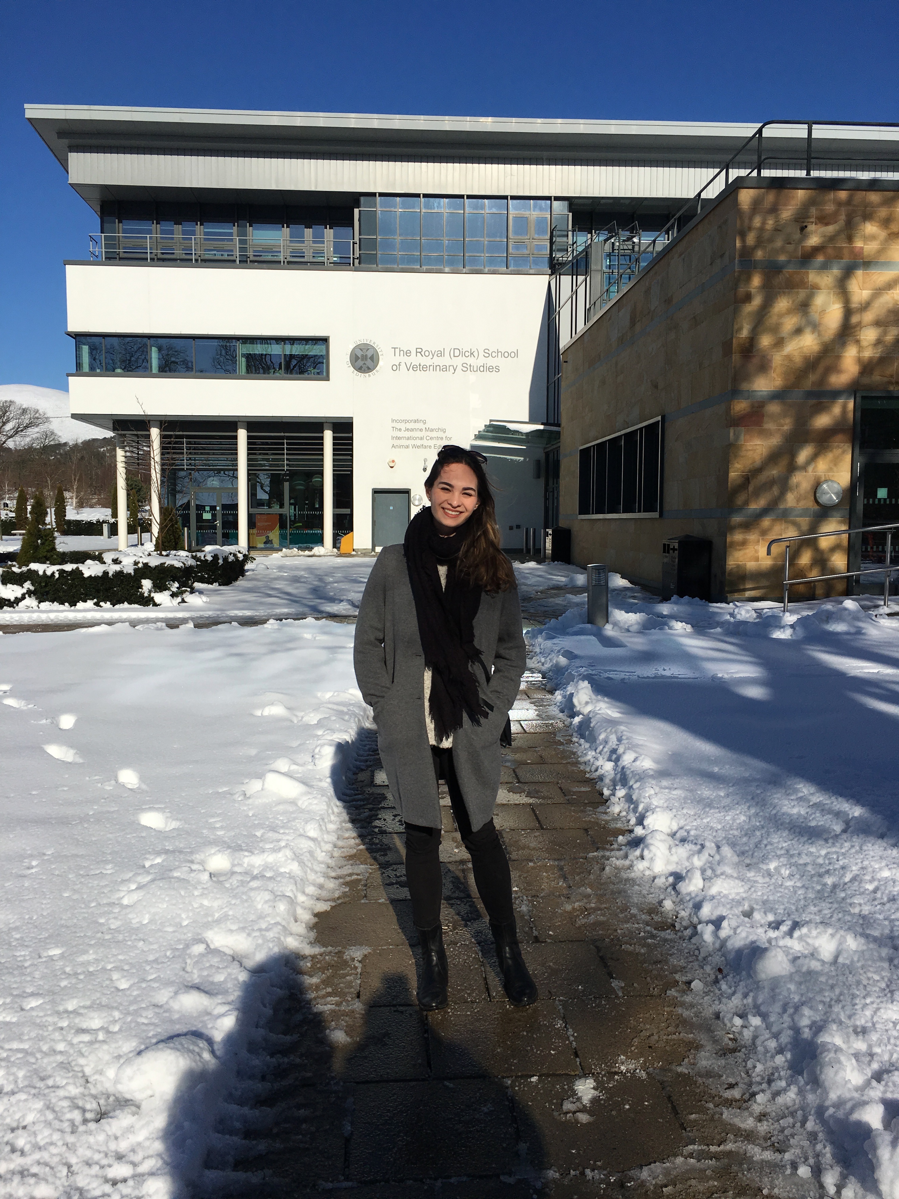 Student standing in front of vet school