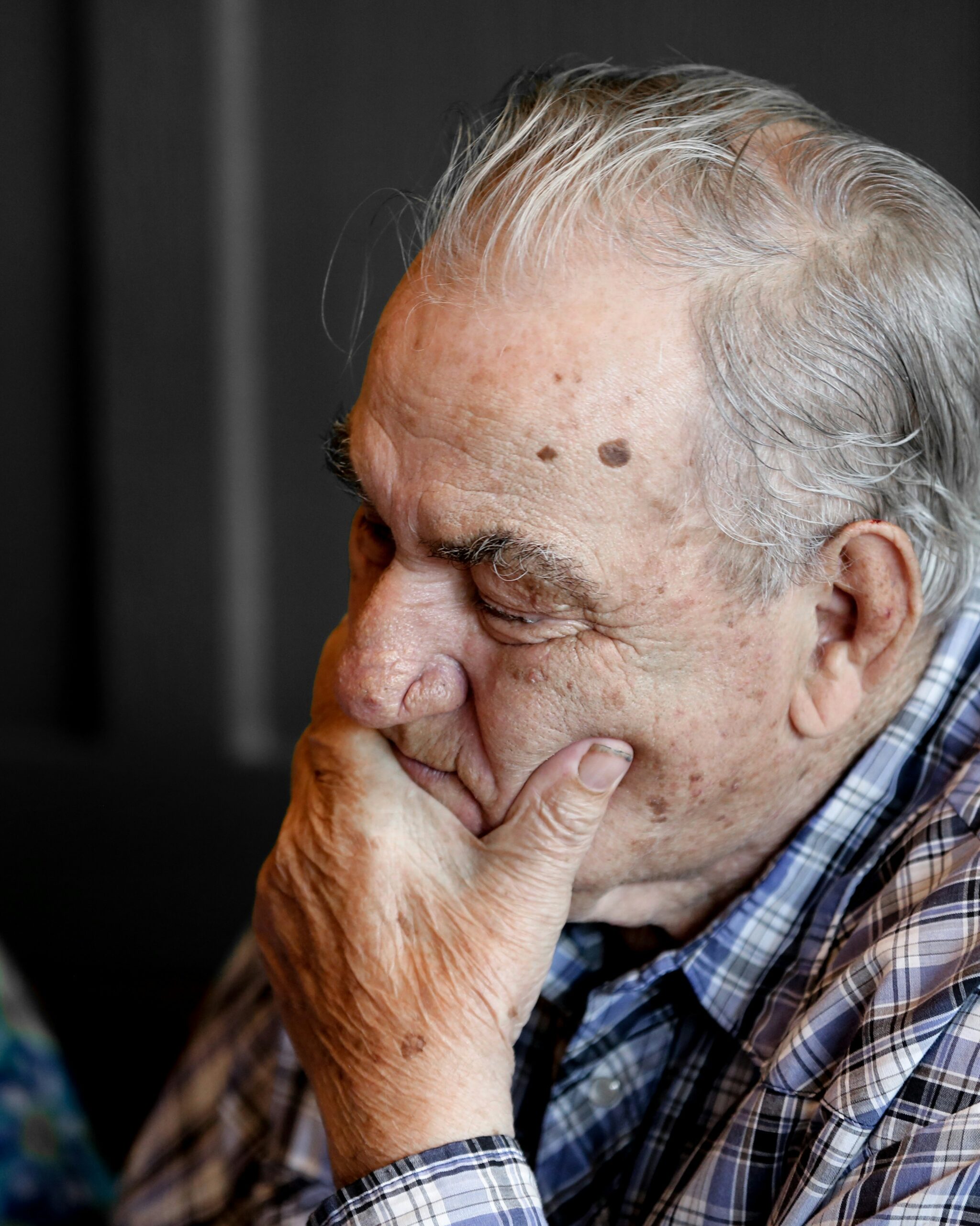 Elderly man holding chin