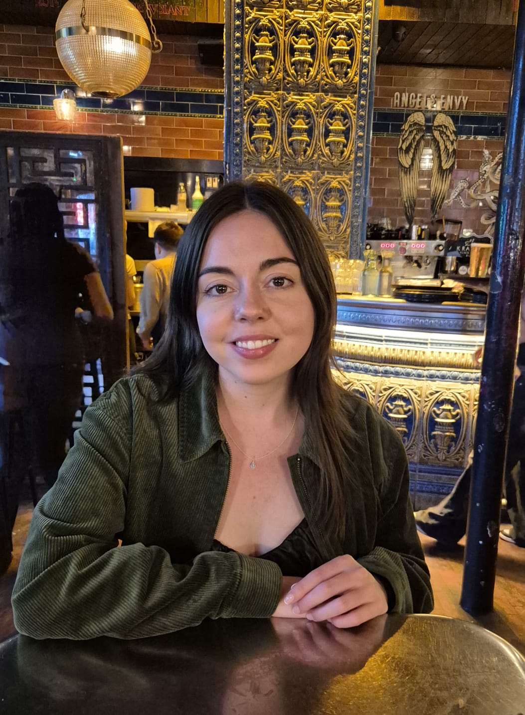 Headshot of a lady sat at a table.