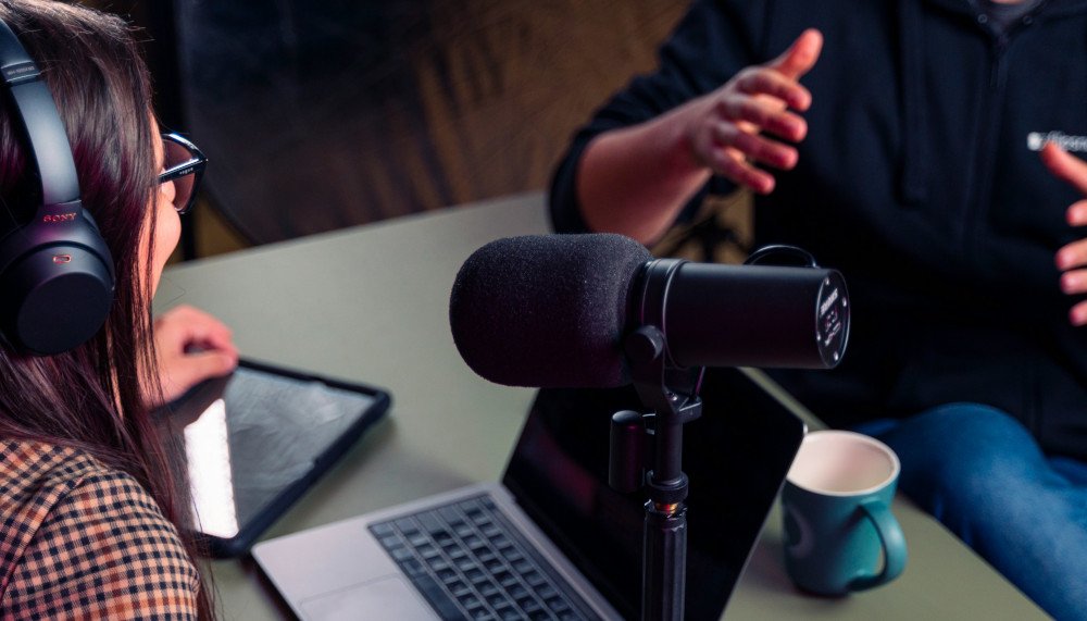 Photo of two people making a podcast