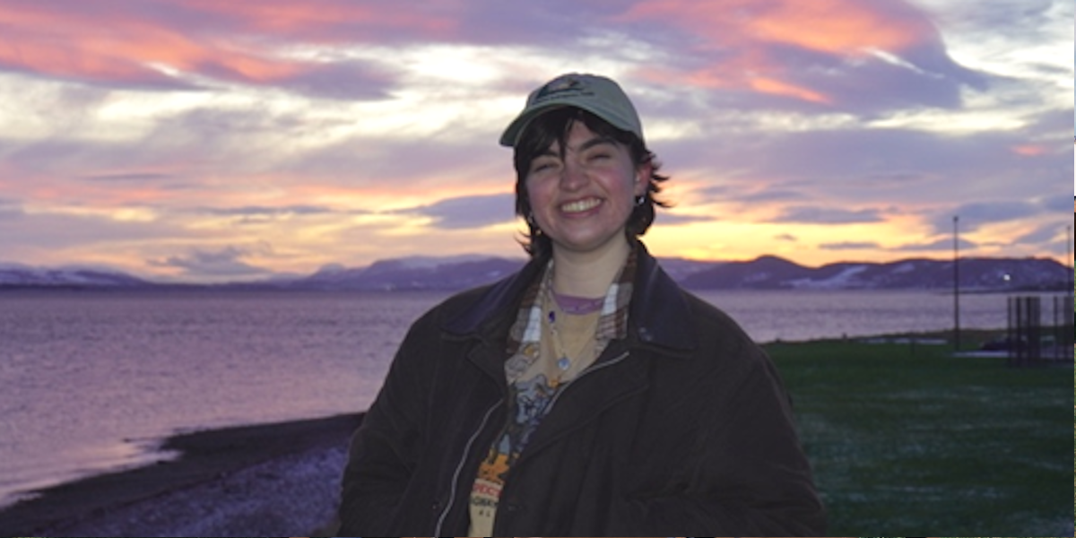 Rachel at sunset with water in the background.