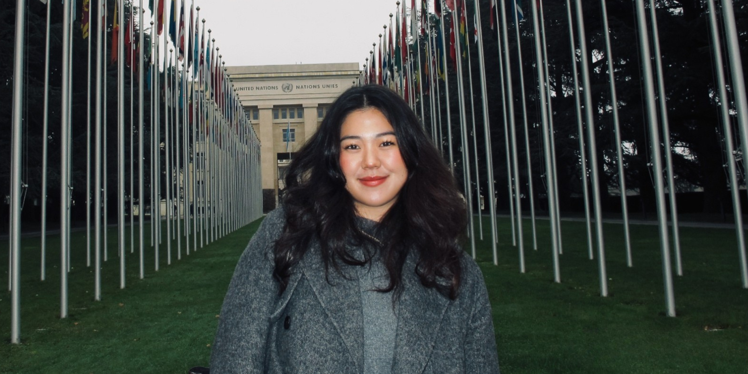 Shirley standing in front of a United Nations building.