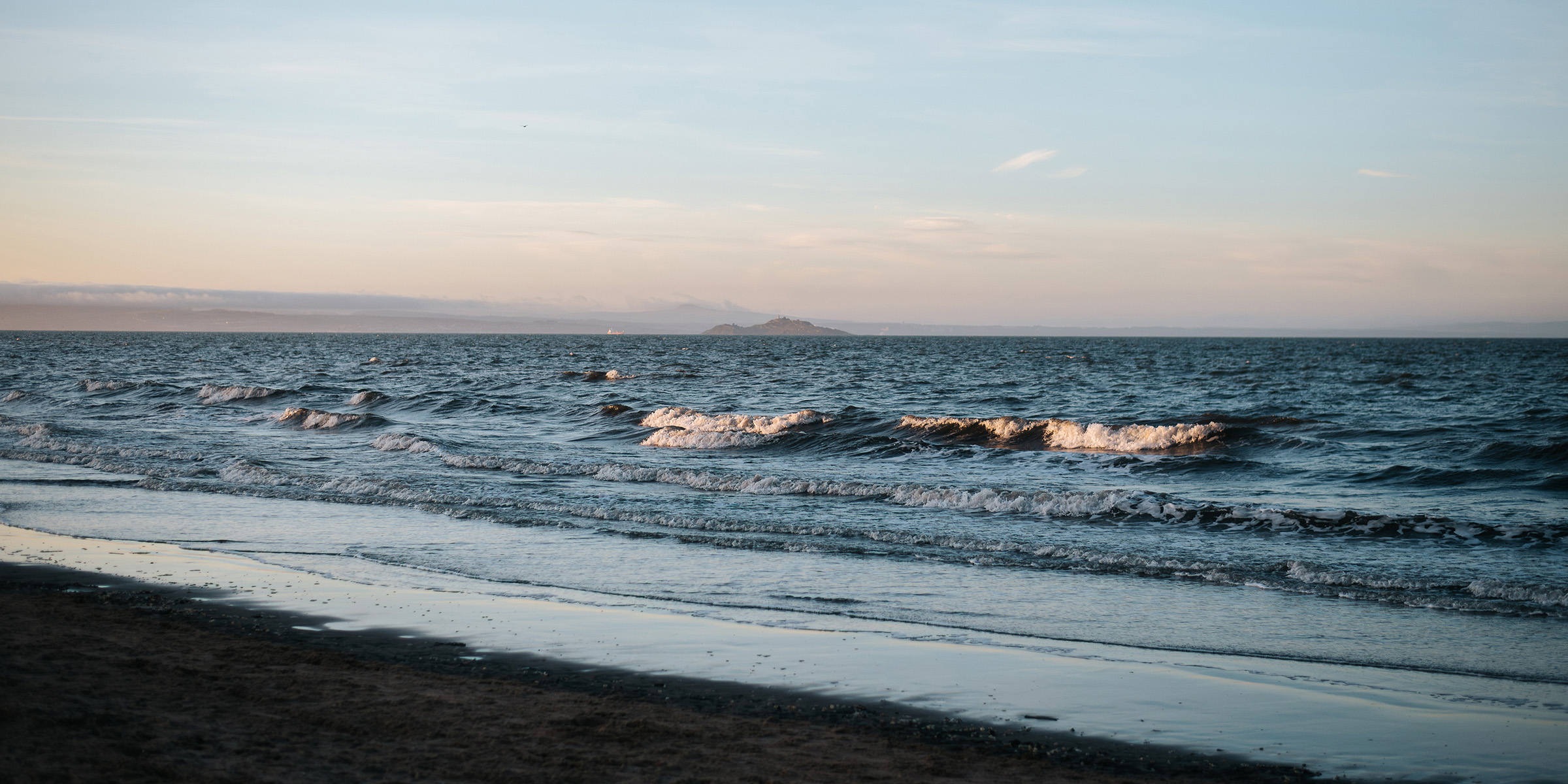 Waves crashing onto a beach.