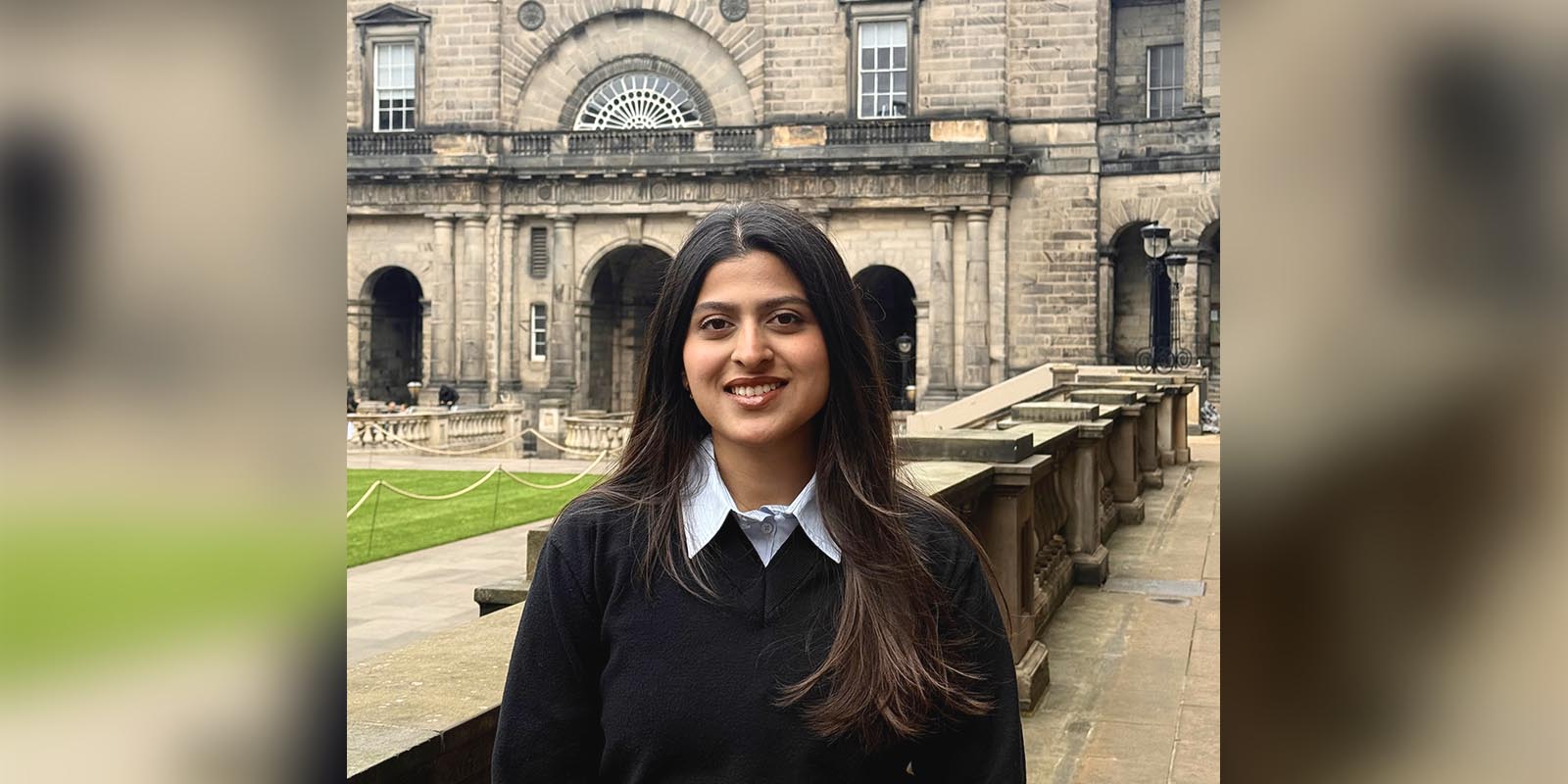 Meetha standing in the Old College quad, smiling at the camera.